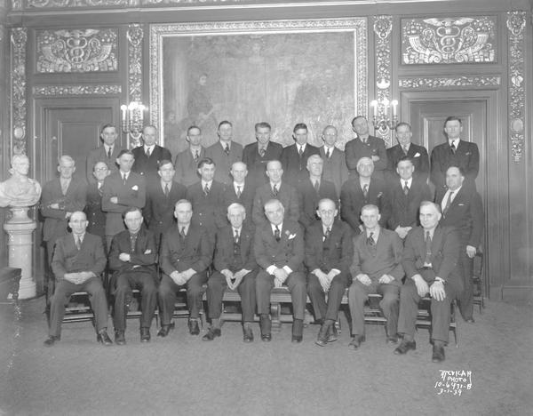 Group portrait of Wisconsin Athletic Association men and Governor Julius P. Heil in the Capitol building.