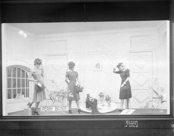 Three mannequins wearing Perry Brown dresses with hats, gloves and purses in the window at Kessenichs, 201-203 State Street.