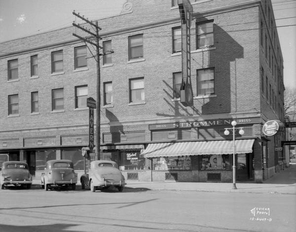 Fort Atkinson street scene showing automobiles parked in front of the Blackhawk Hotel Tavern and Strommen Drug Store.
