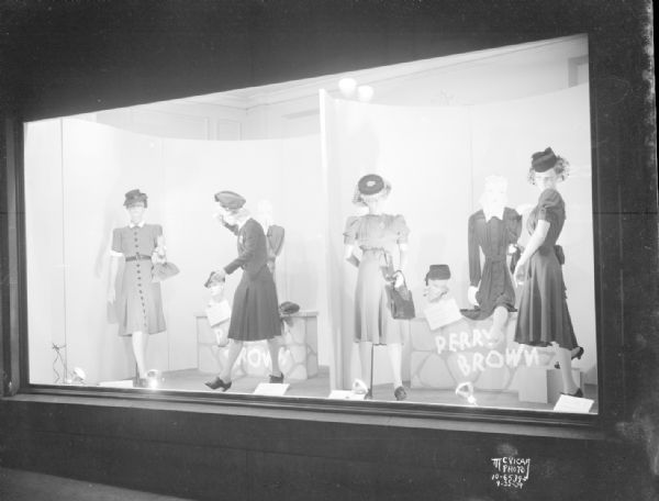 Four mannequins in Kessenich's window wearing Perry Brown dresses, with hats, gloves, and purses. 201-203 State Street.
