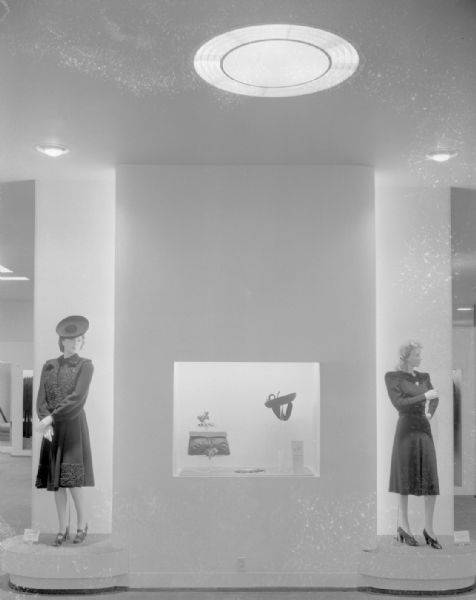 Manchester's, Inc., Department Store, 2-6 East Mifflin Street, window display with two mannequins wearing dresses flanking a display of a purse and hat.