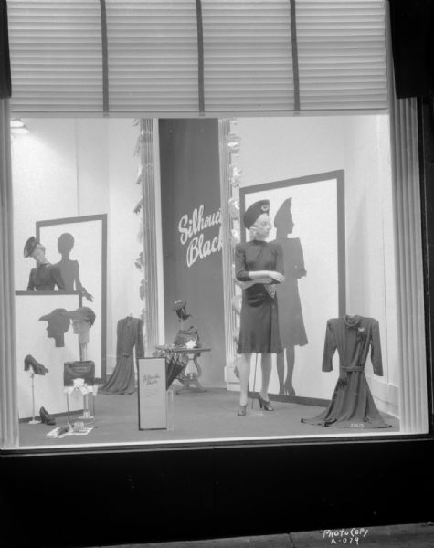 Manchester's, Inc., Department Store, 2-6 E. Mifflin Street, "Silhouette Black" window display, with mannequin in a dress and hat, with display of dresses, shoes, purses and gloves.