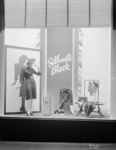 Manchester's, Inc., Department Store, 2-6 E. Mifflin Street, "Silhouette Black" window display, with mannequin in a dress with hat, and other dresses and accessories.