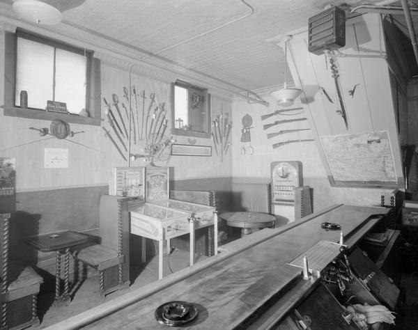 Interior of Dutch Tavern, 121 North Blount Street, featuring pinball and cigarette machines.