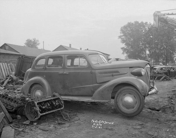 Undamaged right side of damaged automobile in O.C. Harris Company junk yard, Highways 12-18-51.