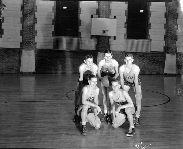 Group portrait of five male Edgewood high school basketball players.