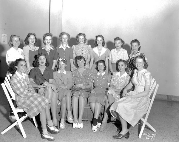 Group portrait of female state employees who have signed up to be hostesses to attend parties given for military men when they are on leave. Seated l to r: Marie Groves, Ethyl Seymour, Betty Fuller, Beatrice Lampert (Hostess Committee Chairman), "B" Gundrum, Irene Burek and Janice Instefjord. Standing l to r: Hazel Koshkenlinna, Margaret Horkey, Margaret Burdick, Claire Suslick, Virginia Wilder, Josephine Star, Virginia Reinsch, and Margery Carter.