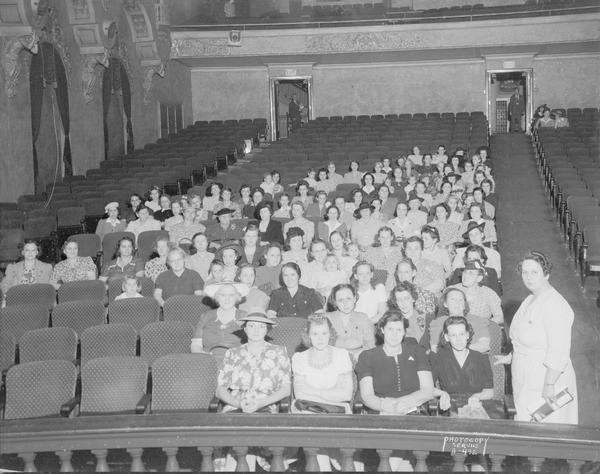 Group portrait of members of the Health for Victory Club. They are sitting in the Eastwood Theater, 2090 Atwood Avenue. The photograph was taken for the Oscar Mayer Company.