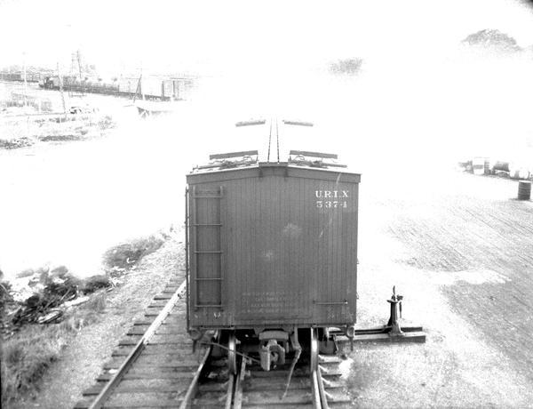 Elevated view of Oscar Mayer refrigerated railroad car, Chicago & Northwestern #URTX 5374, with view of Oscar Mayer railroad yards.