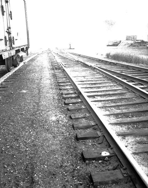 Railroad tracks at Oscar Mayer plant. There is a railroad car on another set of tracks on the left.