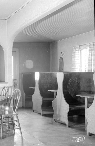 Interier view of Dobby's Cosmo Club, owned by John C. Dobson, Route 1, Mendota Wisconsin, showing water damage on arch above the booths.