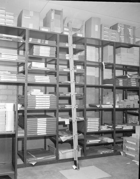 Closed ladder against trade shelves at Madison-Kipp Corp., 201-231 Waubesa Street.