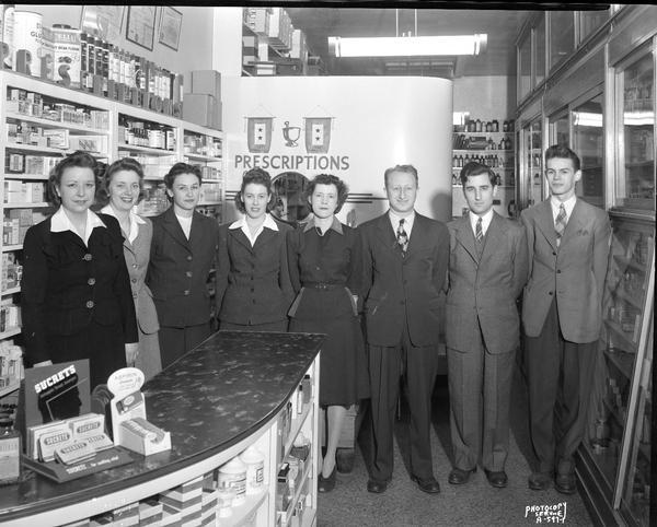 Prescription Pharmacy at 20 South Carroll Street, interior view.  Employees group posing for Christmas card photograph, Samuel R. Chechik, Pharmacist.