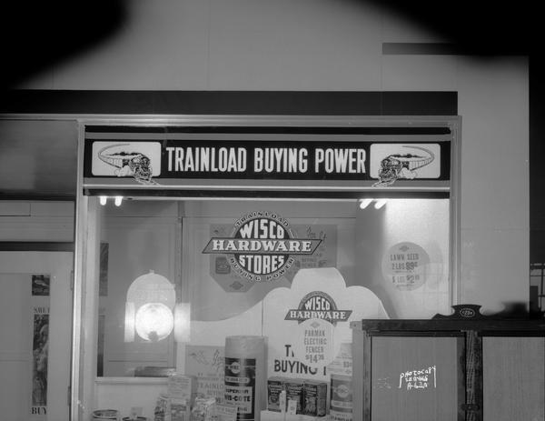 Display window at Wisco Hardware Store, 15 South Brearly Street, featuring "Trainload Buying Power."
