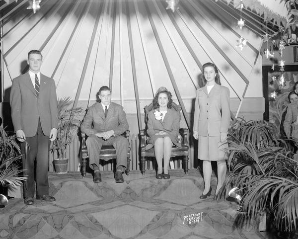 Close-up of Caryl Coyle and Alex McCormick, who will be the Queen and King of the Edgewood High School Junior Prom to be held in May,  photographed at the Edgewood High School Mardi Gras party in February when their names were announced. They are sitting under a canopy, flanked by Robert O'Brien and Kathleen Kellogg who were the previous year's Junior Prom King and Queen.