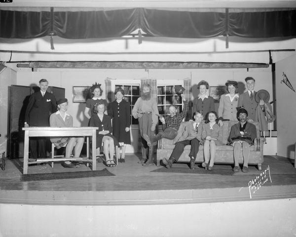 Group portrait of thirteen players in costume, cast in a play at St. James School, 1204 St. James Court.