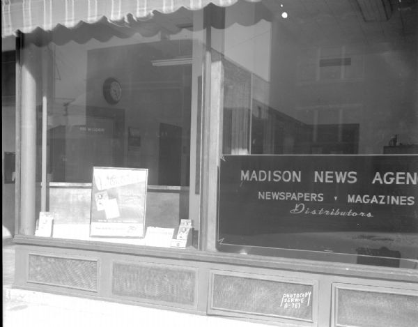 Exterior view of Madison News Agency, 446 West Gilman Street. <i>Coronet</i> magazine poster is in one of the windows.