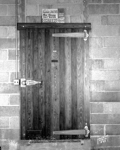 Vogel Fish and Oyster Company, 2049 Atwood Avenue, door to the large refrigeration room, sign above door reading: "Captain Jack's Oysters sold here."