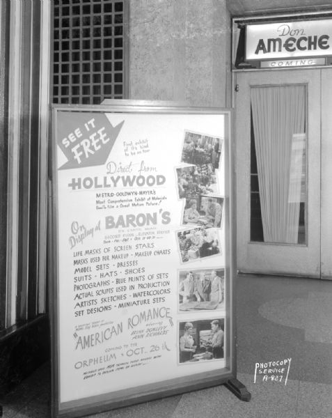 Orpheum Theatre lobby, 216 State Street, with sign with description of items on display at Baron's Department Store that were used to produce "American Romance," starring Brian Donleavy and Ann Richards.