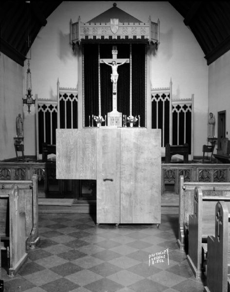 Portable confessional, manufactured by Burgess Manning Company, set up in front of the altar at Blessed Sacrament Church, 2119 Rowley Avenue.