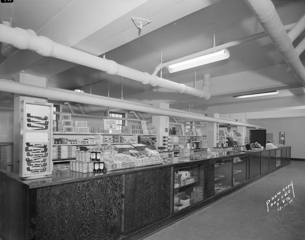 Interior view of U.S. Navy Ship Service Store with merchandise display on counter and shelves.
