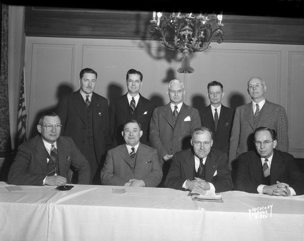 Wisconsin Motor Vehicle Department Safety Convention, with a group portrait of nine morning speakers, taken at the Loraine Hotel, 123 West Washington Avenue.