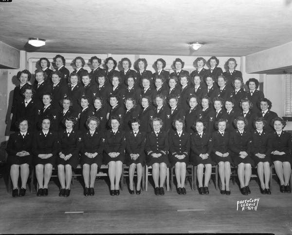Group portrait of United States Navy WAVES (Women Accepted for Volunteer Emergency Service) attending the Army-Navy Institute on the University of Wisconsin campus.