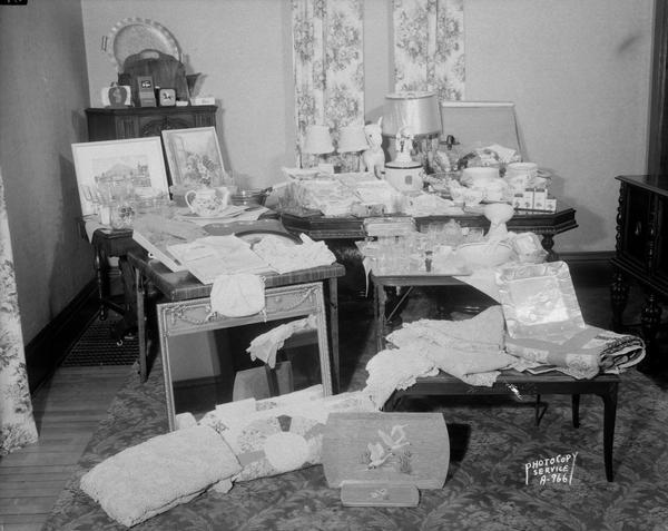 Display of gifts for Virginia M. Cordary and Floyd A. Tarbox wedding in dining room of Frank Cordary home at 522 South Mills Street. The couple was married on February 23, 1945. Floyd was a mechanic at Koch Motors. Frank G. Cordary and Agnes were candy makers at the chocolate shop.