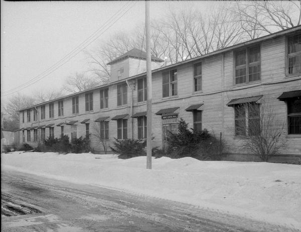 Kleinheinz Hall (old Sheep Barn) at 1815 Linden Drive on University of Wisconsin-Madison campus. Building was used as housing for United States Navy Radio School students during World War II 1941-1945. Otherwise building was used to house University of Wisconsin School of Agriculture Short Course students. Alternate view.