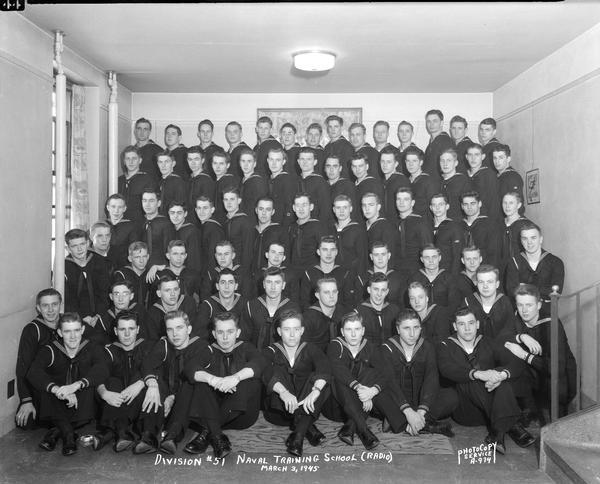 Group portrait of U.S. Naval Training School (Radio), Division #51, trainees, taken in the Rose Taylor Room in Kronshage Hall, University of Wisconsin-Madison.