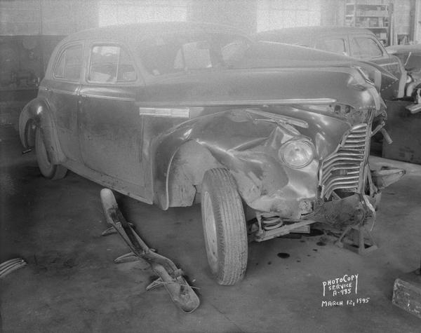 Wrecked Buick sedan (owned by E.J. Morse) at the Royal Body Company, 9-13 Brooks Street, showing right side damage.
