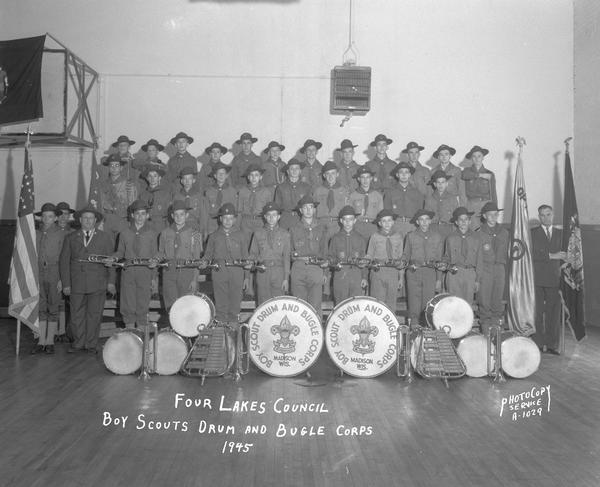 Group portrait of the Four Lakes Council Boy Scouts Drum and Bugle Corps, with instruments.
