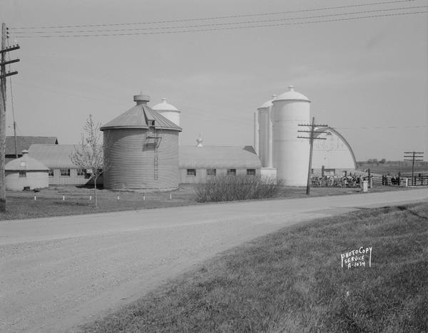 Wisconsin Conference of Seventh Day Adventists farm buildings including barns, three silos and a corn crib on Duborg Road off of Highway 16 west of Columbus.