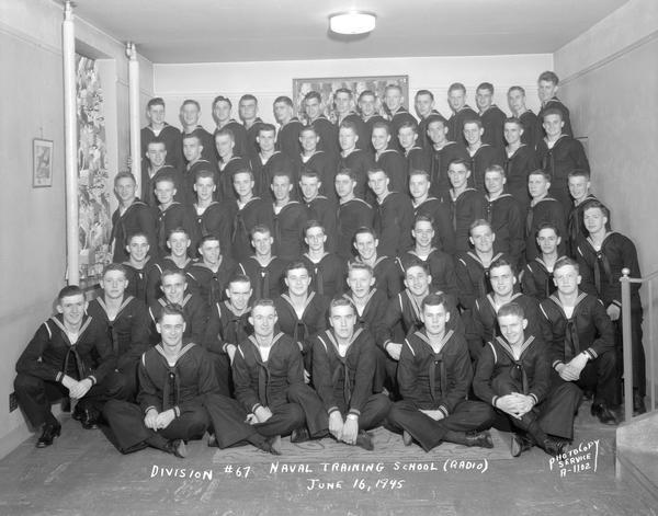Group portrait of U.S. Naval Training School (Radio), Division #67, trainees at University of Wisconsin-Madison.