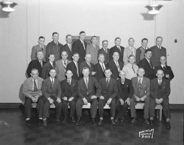 Group portrait of University of Wisconsin-Madison Heating Plant employees, members of Wisconsin State Employees Association Heat & Water Local 171, organized in 1935. Machinist Tony Nilles is at the right end of the second row.