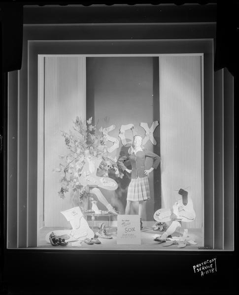Female mannequin with a display of socks in a display window at the Harry S. Manchester, Inc. department store, 2 East Mifflin Street.