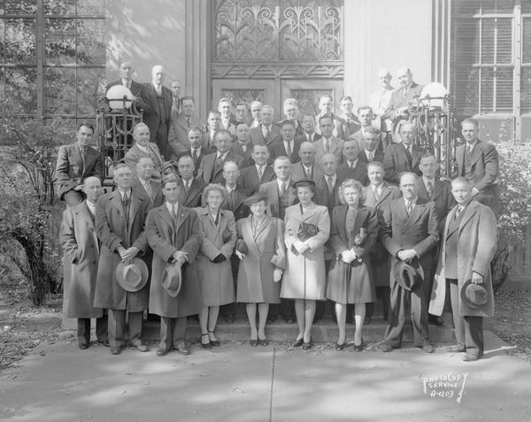 Outdoor group portrait of the Federation of State, County and Municipal employees outside the Federation Building, 448 W. Washington Avenue. Photograph taken for State Employee magazine.