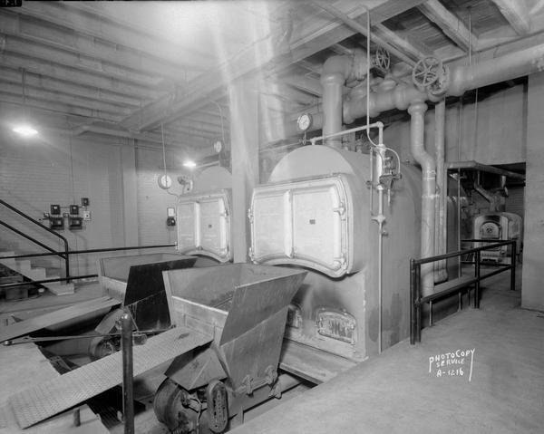 Anchor stokers and Kewaunee boilers in the Marquette School basement. Taken for Pharo Heating.