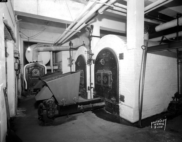 Anchor stokers and Kewaunee boilers in the basement of Longfellow School, taken for Pharo Heating.