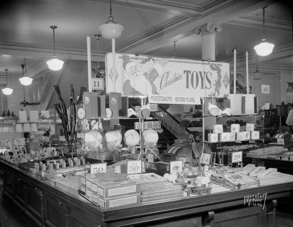 Christmas toy display at F.W. Woolworth, 1 East Main Street. Sign includes an image of Santa Claus.