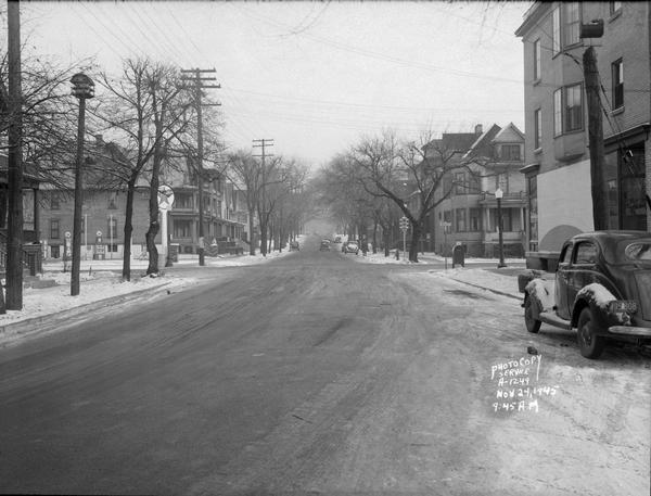 Looking east on 500 block of West Johnson Street toward North Bassett Street showing Irven Krause Grocery and Market, 222 North Bassett Street and Erickson Texaco Gas Station, 307 North Bassett Street.