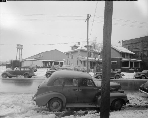 Ray-O-Vac buildings on 2300 block of Winnebago Street. An office building, production plant, water tower, and two houses at 2327 & 2331 Winnebago Street can also be seen.