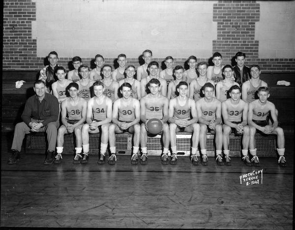 Group portrait of Edgewood High School male basketball squad in gymnasium.