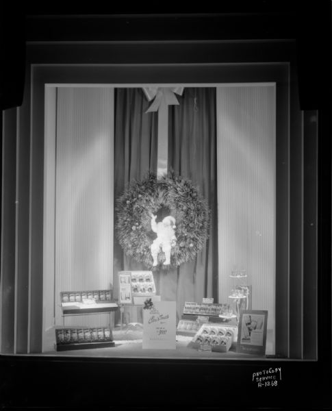 Window display at Manchester's, Inc., featuring Libbey glassware and a Christmas wreath.