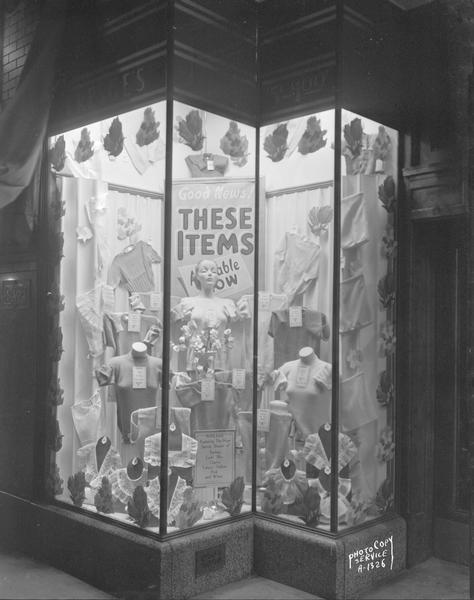 Sweater window at Kresge's Dollar store, 13-15 South Pinckney Street, featuring the new spring shades, taken at night.