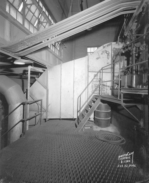 Interior view of the Madison Gas & Electric Company, showing metal floor and stairway, windows and beam arrangement, 115 South Blount Street.