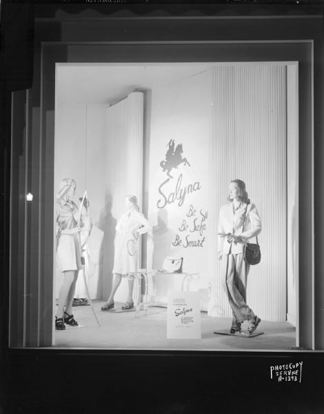 Window display at Harry S. Manchester's, Inc., featuring four mannequins wearing sportswear made from Salyna, "a washable, wonderful spun rayon fabric."