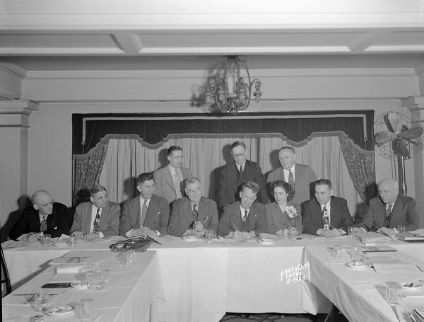 Group portrait of ten men and one woman, the executive board, of the CUNA (Credit Union National Association) Supply Company at the Loraine Hotel.