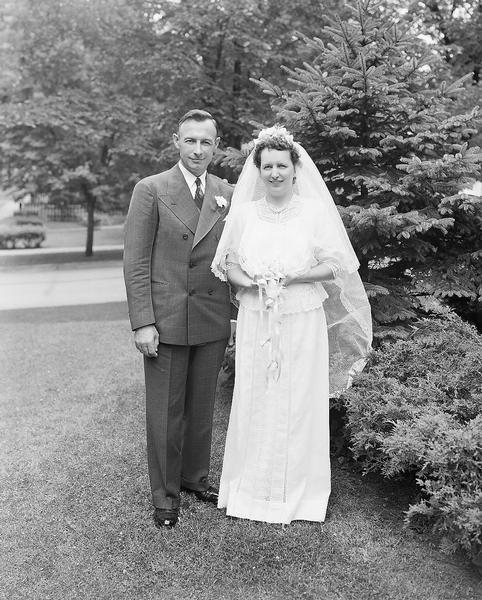 Outdoor portrait of the Kolb-Young wedding, with the bride Dorthy E. Kolb, wearing her mother's wedding dress, and the groom Claude A. Young.