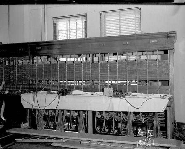 Telephone switchboard being rebuilt at the Madison Exchange of the Wisconsin Telephone Company.